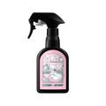 A black plastic trigger spray bottle of Lush "Cloudberry Body Spray". The pink front label features comic strip illustrations of Moomin characters and bold text reading "LUSH x MOOMIN".