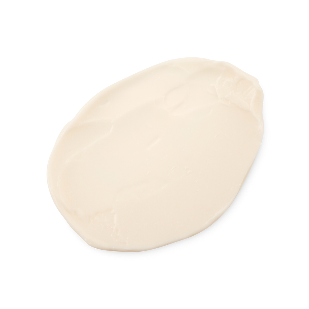 A swatch of smooth, thick, light cream coloured Dirty hair styling cream.