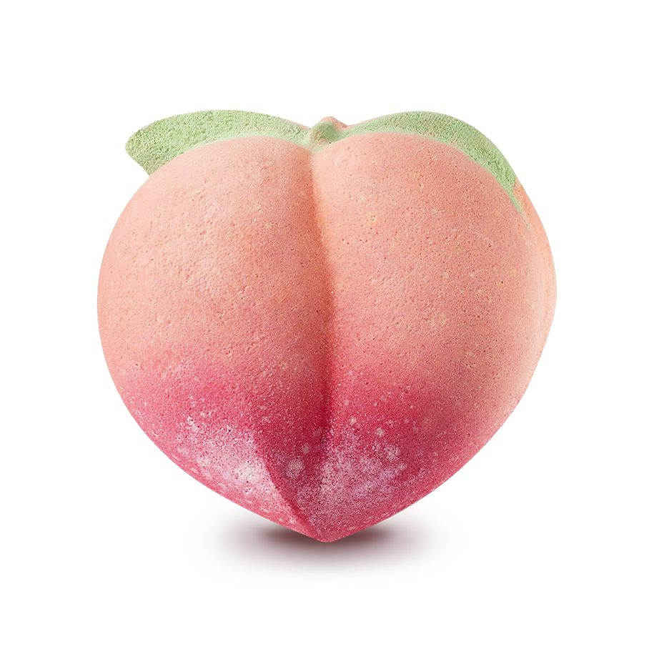 Peachy. A peach-shaped bath bomb featuring a soft orange and pink gradient, darkening to a deep pink at the base. Two small green leaves are moulded at the top near the stem.